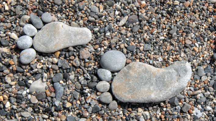 Füße aus Steinen am Strand (Quelle: Axel Hartmann)