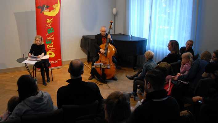 Blick von oben ins Publikum, vorn Schauspielerin Antje von der Ahe und Musiker Martin Lillich (Quelle: rbb/OHRENBÄR/Birgit Patzelt)